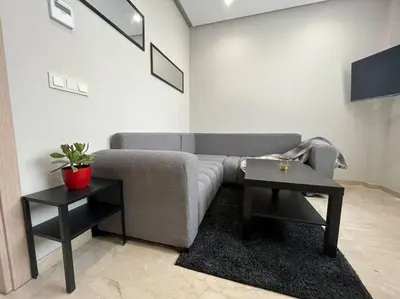 a living room with a couch and two tables at Modern Cosy Studio Anfa in Casablanca