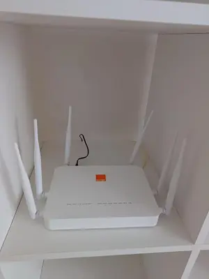 a white router sitting on top of a shelf at Apartment kamal park E21 in Mohammedia