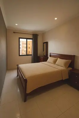 a bedroom with a bed and a window at Bel appartement avec une belle vue sur la grande mosquée Hassan II et la mer in Casablanca