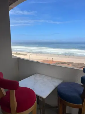 a room with a table and chairs and a view of the beach at Marina Casablanca Ocean view in Casablanca