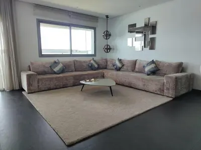 a living room with a couch and a table at Marina Casablanca Ocean view in Casablanca