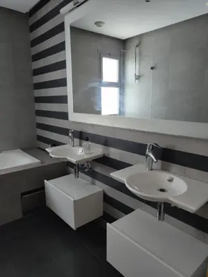 a bathroom with two sinks and a mirror at Marina Casablanca Ocean view in Casablanca
