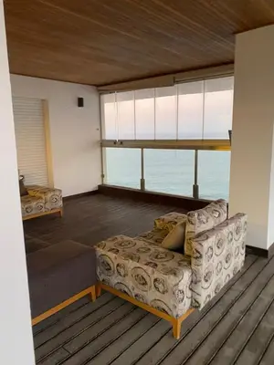 a living room with a couch and some windows at Marina Casablanca Ocean view in Casablanca