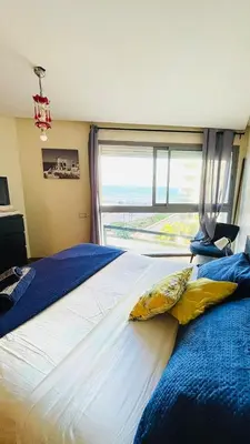 a large bed with two pillows on it in a bedroom at Marina Casablanca Ocean view in Casablanca