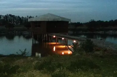 a building on a dock in the water at night at Escape! Ultimate Getaway for Friends in Casablanca