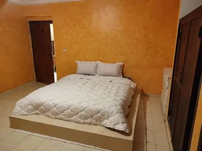 a bedroom with a large bed with white sheets at Escape! Ultimate Getaway for Friends in Casablanca