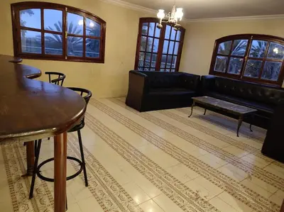a living room with a black couch and a table at Escape! Ultimate Getaway for Friends in Casablanca