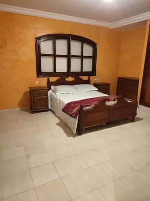 a bedroom with a large bed and two night stands at Escape! Ultimate Getaway for Friends in Casablanca