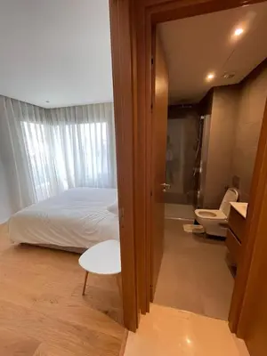 a bedroom with a bed and a bathroom with a toilet at Luxury Appt casa finance City CFC-Aeria Mall in Casablanca
