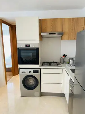 a kitchen with a stove and a washing machine at Luxury Appt casa finance City CFC-Aeria Mall in Casablanca