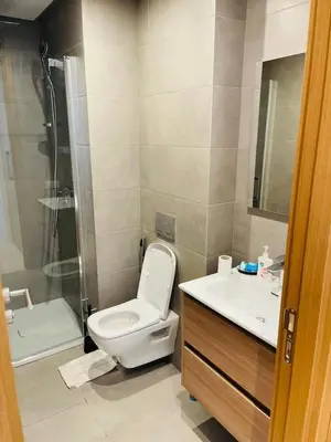 a bathroom with a toilet and a shower and a sink at Luxury Appt casa finance City CFC-Aeria Mall in Casablanca