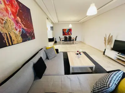 a living room with a couch and a table at Chic & cosy Flat Near Airport lockbox fast wifi in Nouaceur
