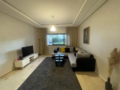 a living room with a couch and a tv at Chic & cosy Flat Near Airport lockbox fast wifi in Nouaceur