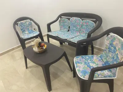 a group of chairs with a bowl of fruit on a table at Beaulieu du Park commode et paisible in Mohammedia