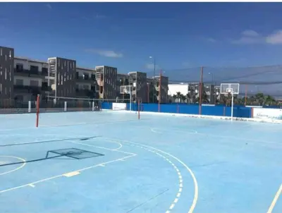 a basketball court with a basketball hoop on it at Grand Apartement a Blanca Beach Sidi Rehal in Sidi Rahal