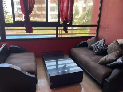 a living room with a couch and a coffee table at Appartement au bord de l'eau in Mohammedia