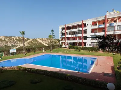 a large swimming pool in front of a building at Appartement au bord de l'eau in Mohammedia