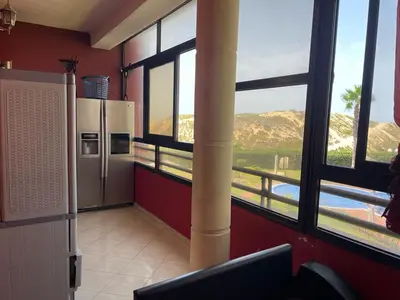 a kitchen with a large window with a view of a mountain at Appartement au bord de l'eau in Mohammedia