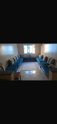a living room with blue couches in a room at Mohamedia in Mohammedia