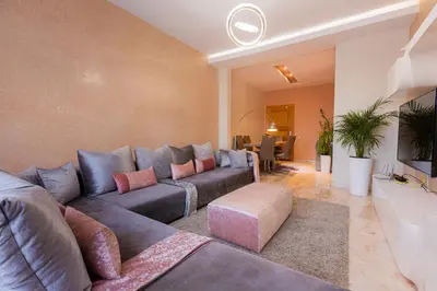 a living room with a couch and a table at AeroChic in Nouaceur