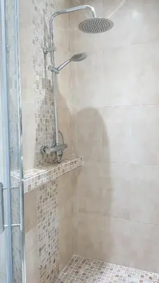 a shower in a bathroom with a glass door at Les Portes de l'Océan avec piscine uniquement l'été in El Harhoura