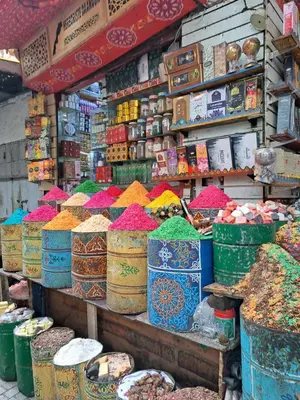 a market with a bunch of different colored spices at Les Portes de l'Océan avec piscine uniquement l'été in El Harhoura