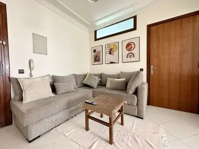 a living room with a couch and a table at Rabat, Appartement Neuf en face d'Arribat Center. in Rabat