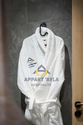 a white towel hanging on a bathroom door at Royal Ocean Suite - By Ayla Stay in Casablanca