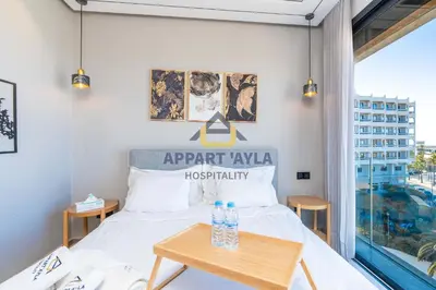 a bedroom with a bed and a table at Royal Ocean Suite - By Ayla Stay in Casablanca