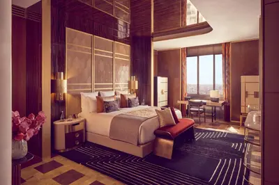 a bedroom with a king sized bed and a desk at Royal Mansour Casablanca in Casablanca