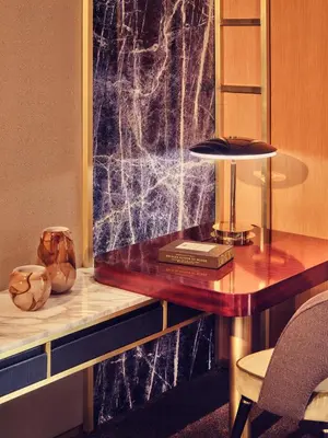 a desk with a book and a lamp on a table at Royal Mansour Casablanca in Casablanca