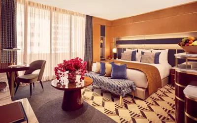 a hotel room with a bed and a couch and a table at Royal Mansour Casablanca in Casablanca