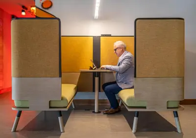 a man sitting at a table with a laptop at Kaan Casablanca in Casablanca