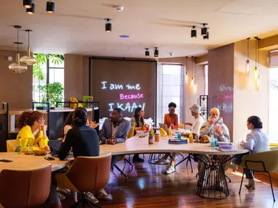 a group of people sitting at tables in a restaurant at Kaan Casablanca in Casablanca