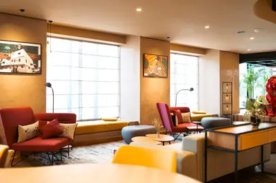 a waiting room with couches and chairs and windows at Kaan Casablanca in Casablanca