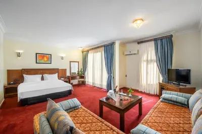 a hotel room with a bed and a couch at Hôtel Club Val d'Anfa Casablanca Ocean view in Casablanca