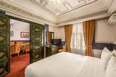 a hotel room with a bed and a television at Hôtel Club Val d'Anfa Casablanca Ocean view in Casablanca