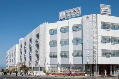 a large white building with people walking in front of it at Hôtel Club Val d'Anfa Casablanca Ocean view in Casablanca