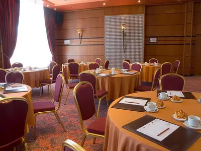 a conference room with tables and chairs in a room at Hôtel Club Val d'Anfa Casablanca Ocean view in Casablanca