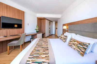 a hotel room with a bed and a desk at Kenzi Basma in Casablanca