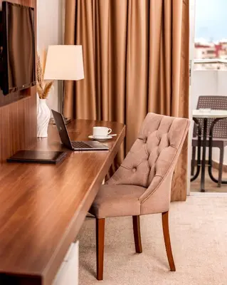a desk with a laptop and a chair in a room at Kenzi Basma in Casablanca