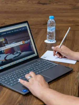a person sitting at a table with a laptop computer at Kenzi Basma in Casablanca