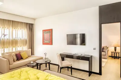 a living room with a couch and a desk at Barceló Casablanca in Casablanca