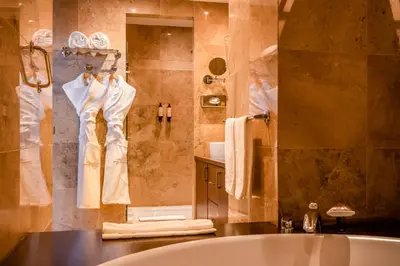 a bathroom with a tub and a robe hanging on a wall at Barceló Casablanca in Casablanca