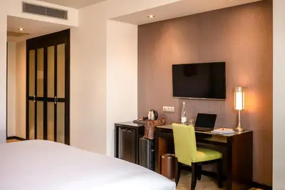 a hotel room with a bed and a desk with a computer at Barceló Casablanca in Casablanca