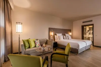 a hotel room with a bed and a couch at Barceló Casablanca in Casablanca