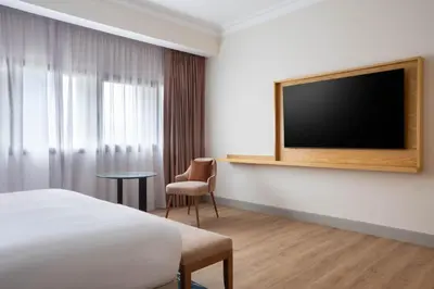 a hotel room with a bed and a flat screen tv at Casablanca Marriott Hotel in Casablanca