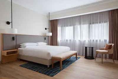 a bedroom with a bed and a chair and a table at Casablanca Marriott Hotel in Casablanca