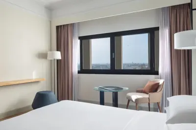 a hotel room with a bed and a chair and a table at Casablanca Marriott Hotel in Casablanca