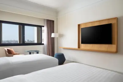 a hotel room with two beds and a flat screen tv at Casablanca Marriott Hotel in Casablanca